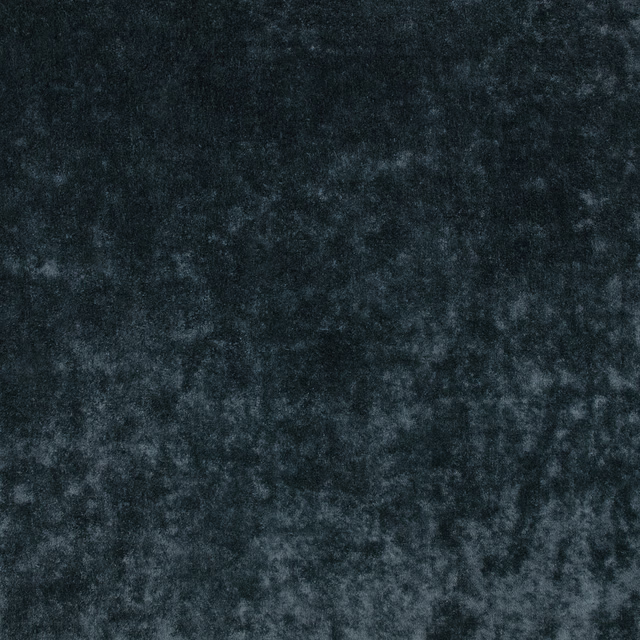Close-up of deep blueberry blue velvet with smoky mottled pile and soft light-catching texture
