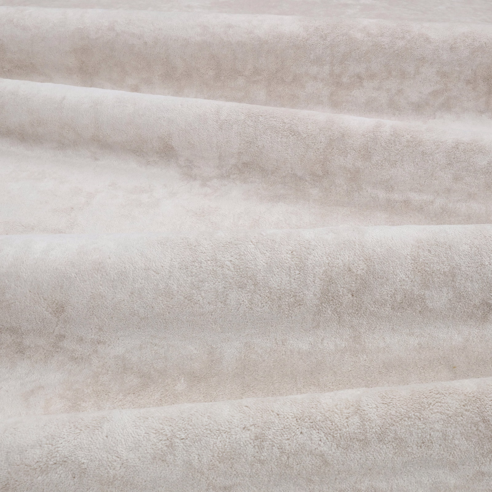 Pale plaster taupe velvet with softly mottled nap and horizontal folded bands