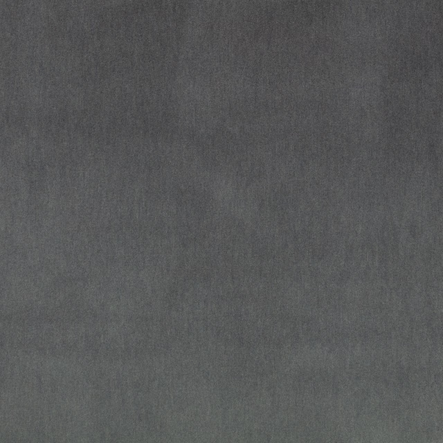 Close-up of deep charcoal-grey velvet with directional nap and subtle muted sheen