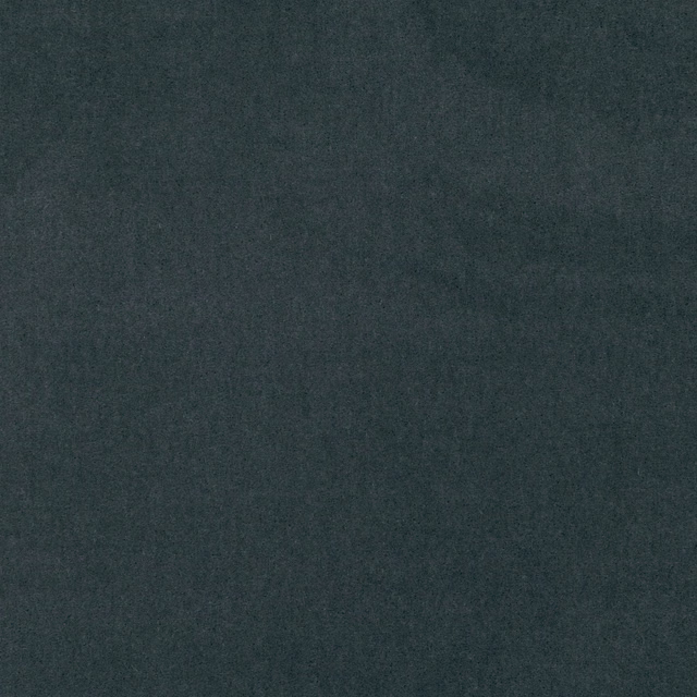 Close-up of deep charcoal velvet with a cool blue-green cast and softly shifting nap