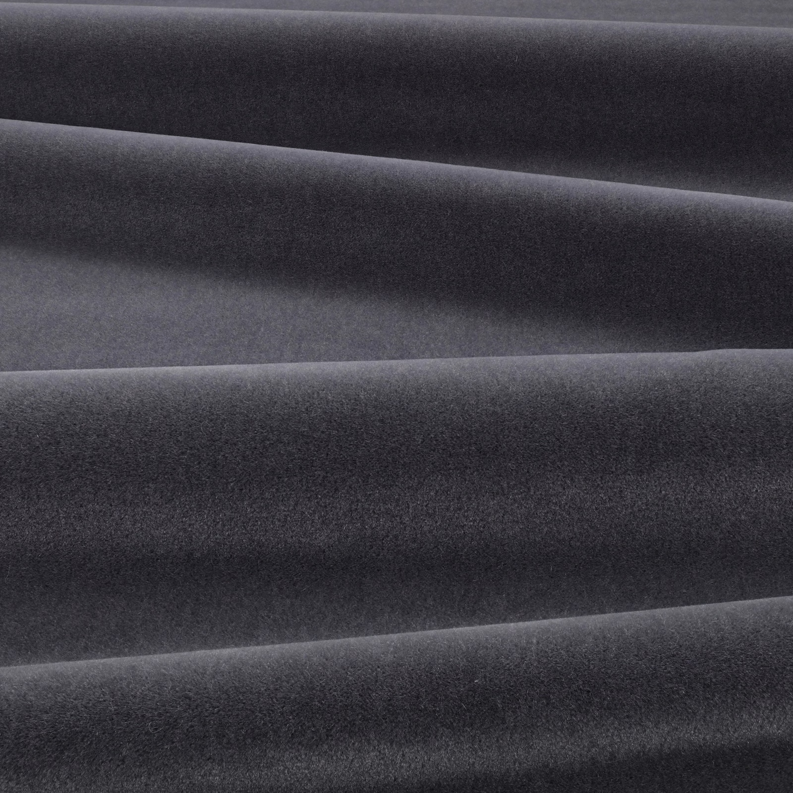 Deep graphite-grey velvet folded into broad ridges, showing a soft directional nap