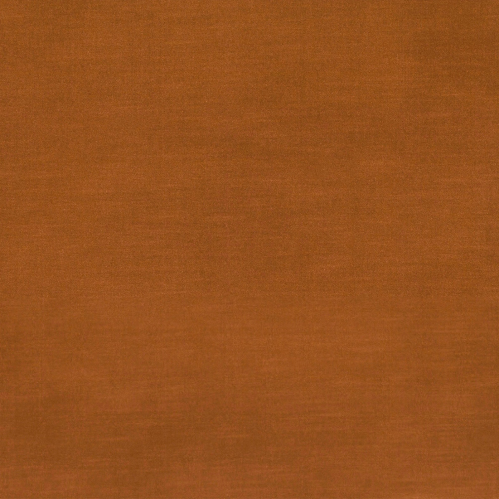 Burnished rust-orange velvet swatch showing subtle directional pile and tonal surface shading