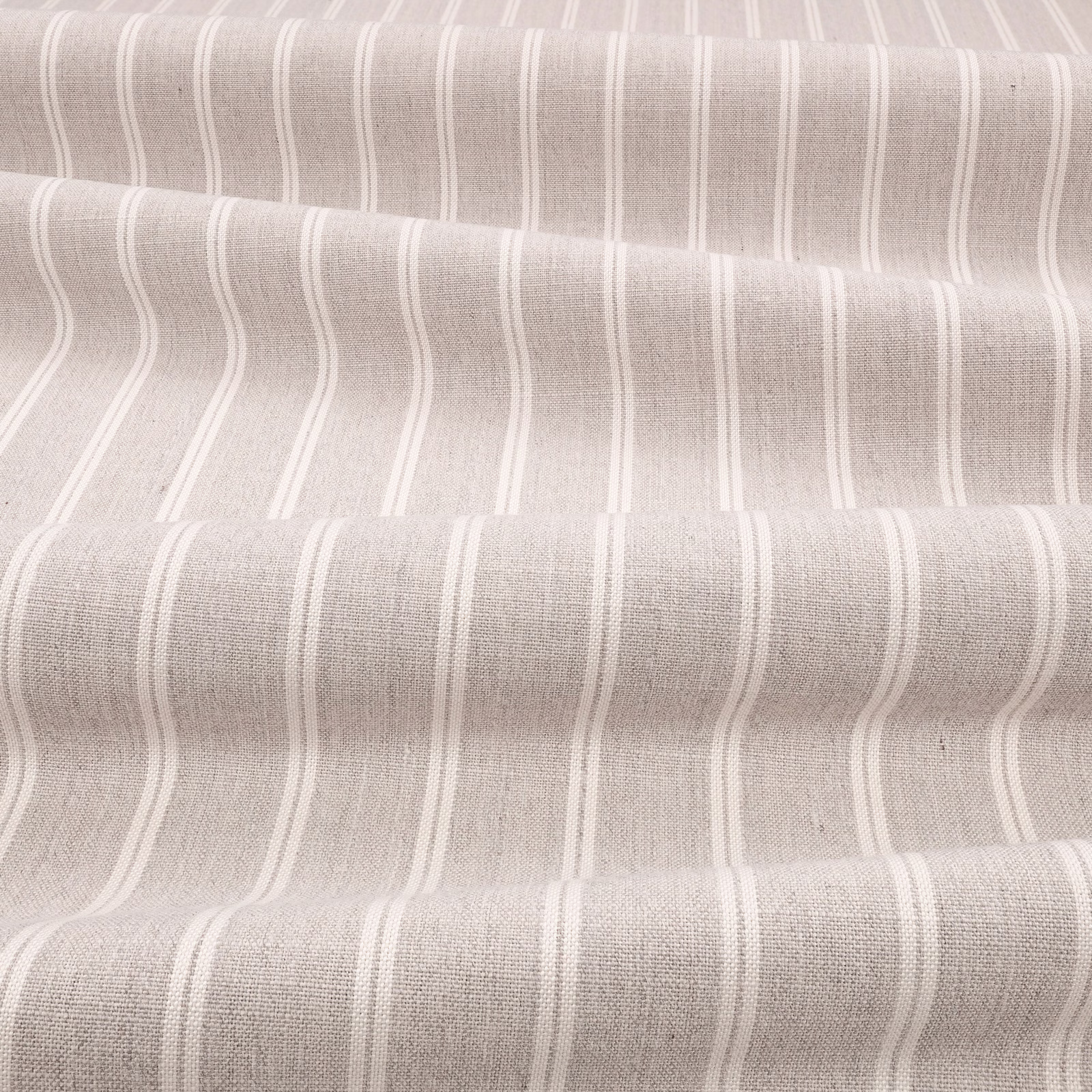 Warm sepia taupe fabric with irregular vertical ivory stripes and fine woven texture