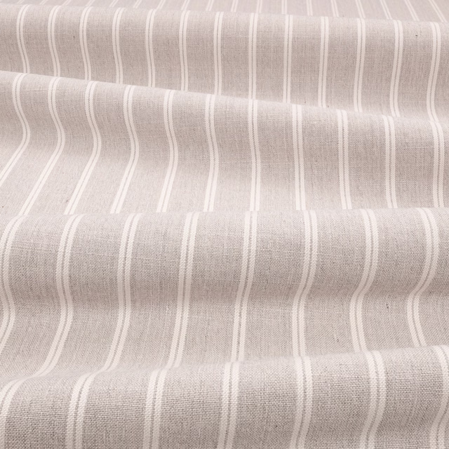Warm sepia taupe fabric with irregular vertical ivory stripes and fine woven texture