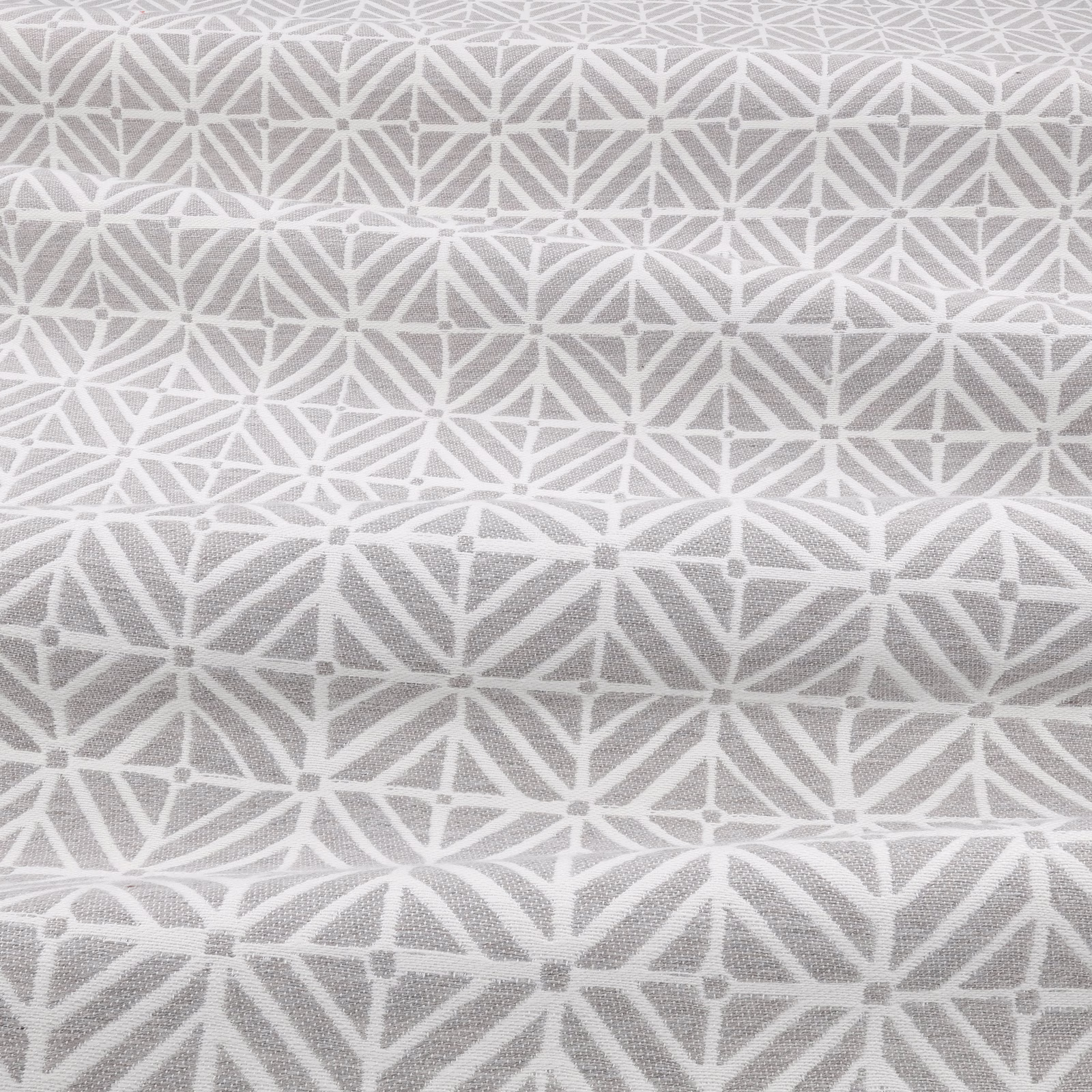 Silverbirch fabric in soft silver grey with a white geometric star lattice