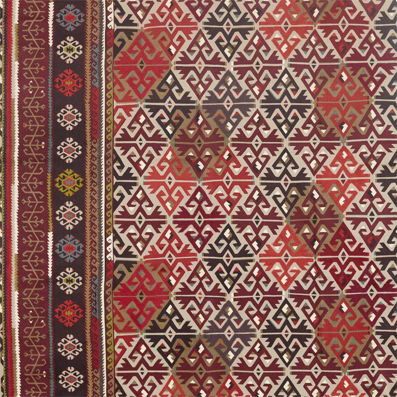 Fig and carmine woven fabric with cream geometric diamonds and a dark patterned border