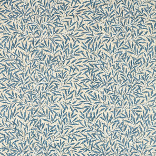 Muted woad-blue leafy branches densely woven across a warm ivory fabric ground