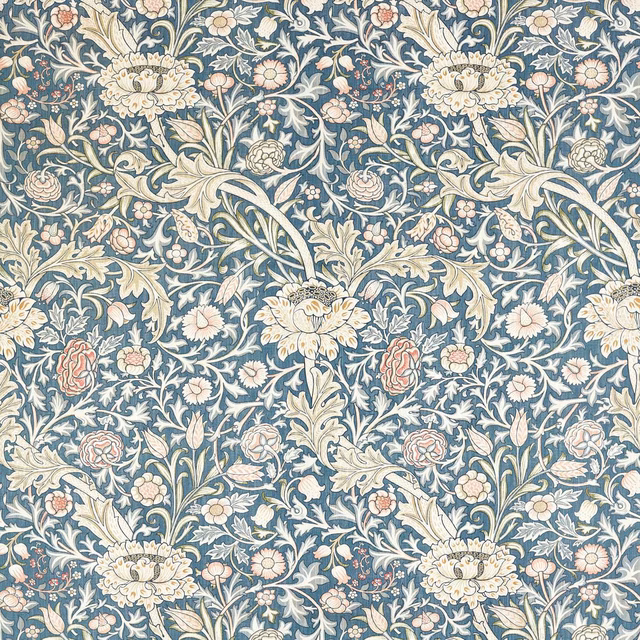 Woad-blue botanical fabric with cream foliage and muted blush flowers