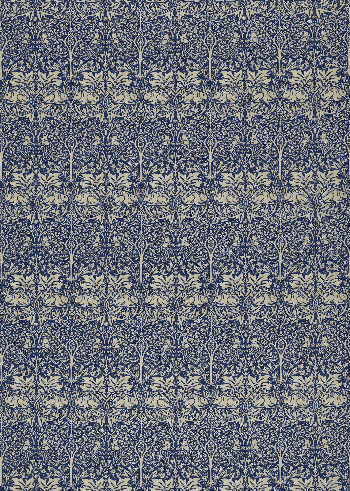 Dense indigo botanical and rabbit motifs repeating over a pale vellum ground