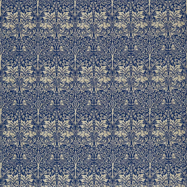 Dense indigo botanical and rabbit motifs repeating over a pale vellum ground