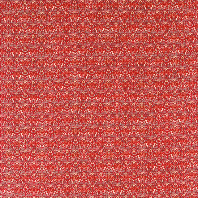 Dense ivory and blush floral motifs across a saturated crimson-red textile