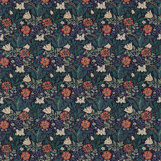 Dark indigo botanical fabric with green leaves, rust flowers and cream blooms