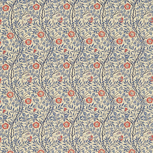 Indigo leafy stems and red flowers arranged across a warm cream floral fabric