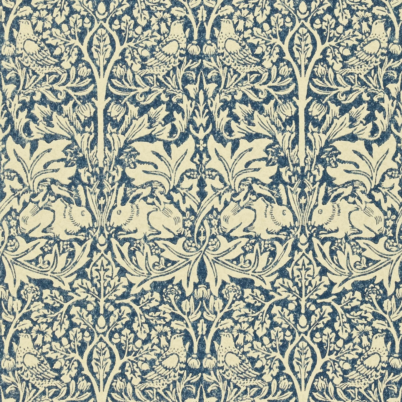 Indigo rabbits, birds and scrolling foliage printed on a warm vellum wallpaper ground
