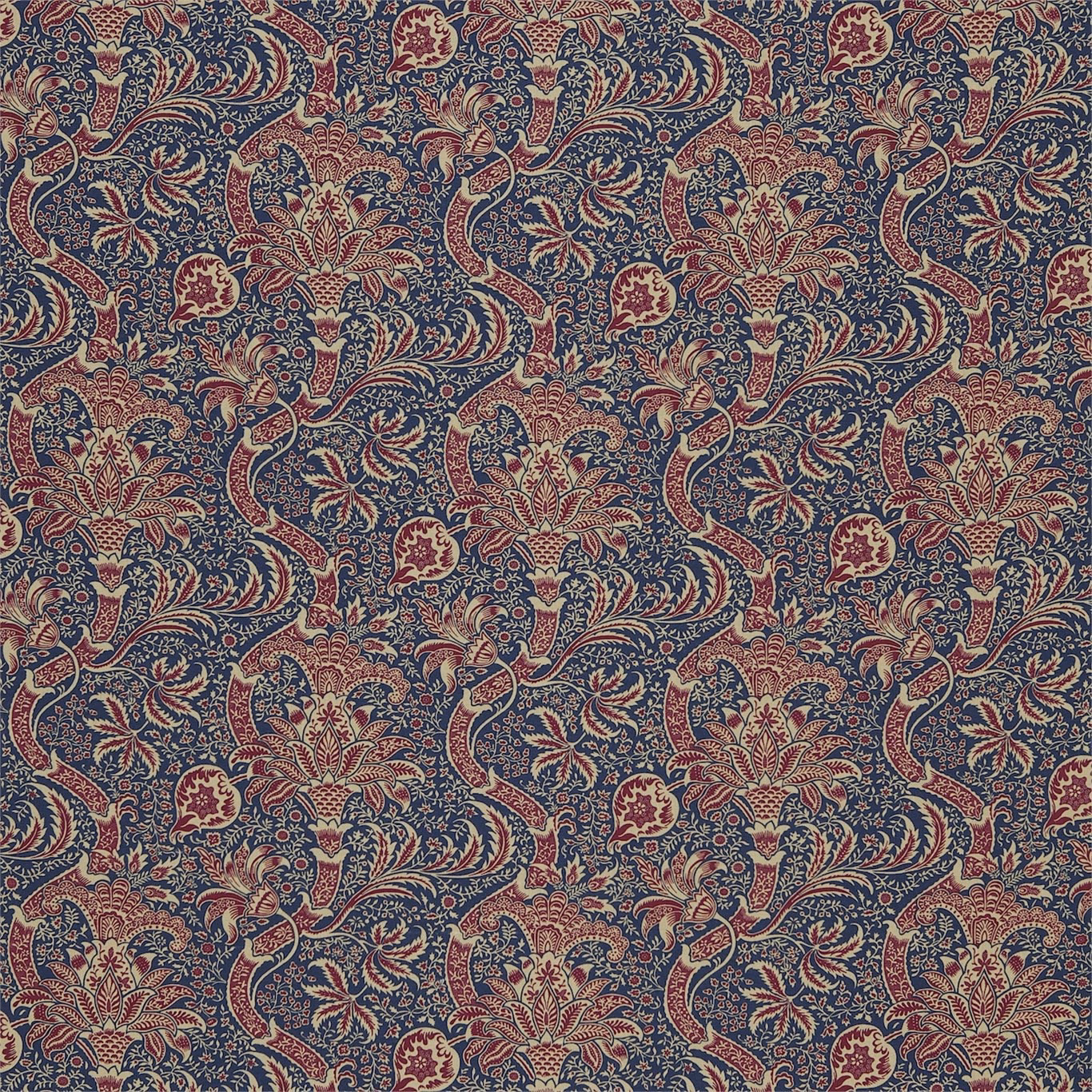 Deep indigo floral scrolls with red, cream and olive motifs on a textured ground