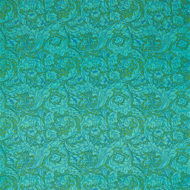 Olive and turquoise scrolling foliage with dense paisley curls across a textile swatch