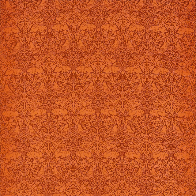 Burnt orange Brer Rabbit fabric with dense tonal botanical and rabbit motifs