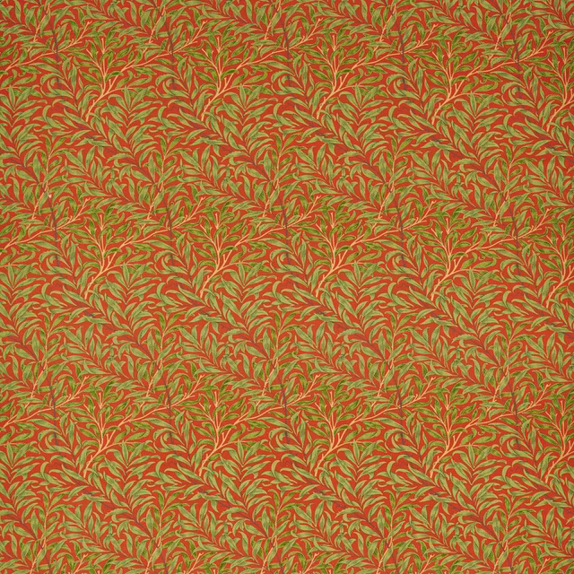 Tomato-red fabric with dense olive boughs and cream leaf accents