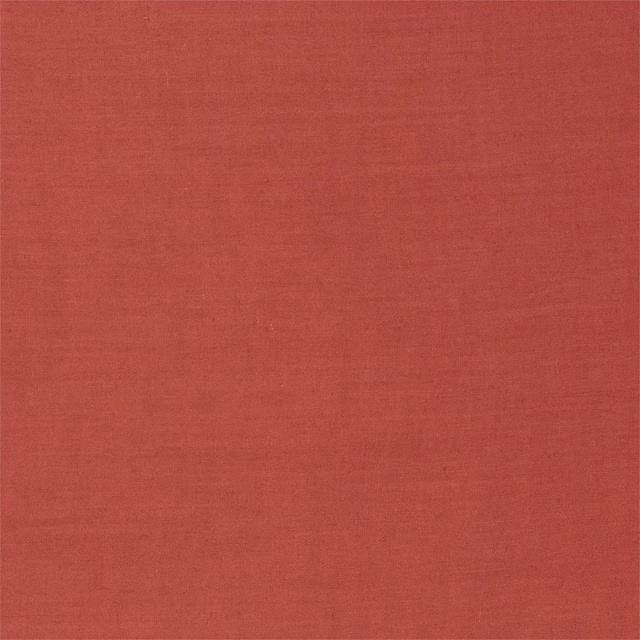 Close-up of warm carmine-red woven fabric with a subtle fine-grained texture