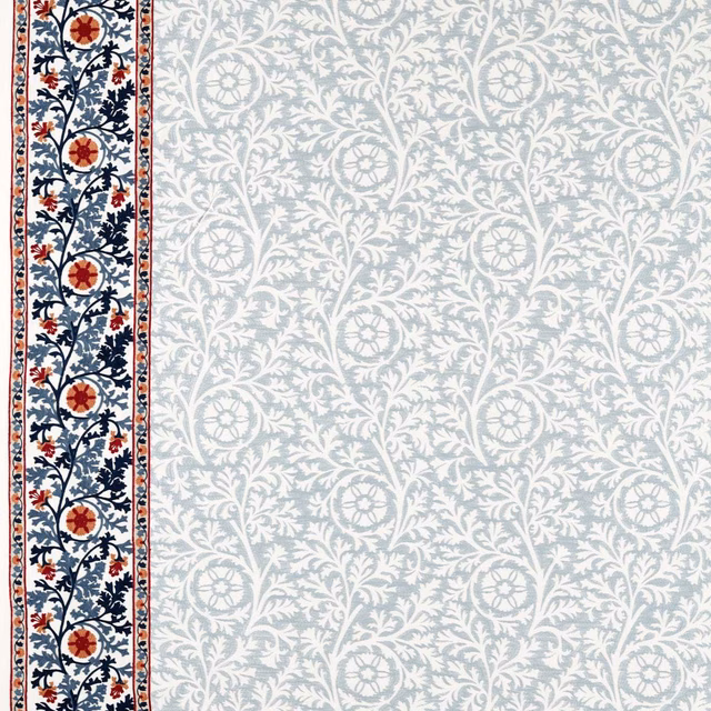 Pale woad floral scrolls with navy vines and rust-red medallion border