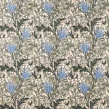 Cream-ground floral fabric with forest foliage and cornflower-blue lily heads