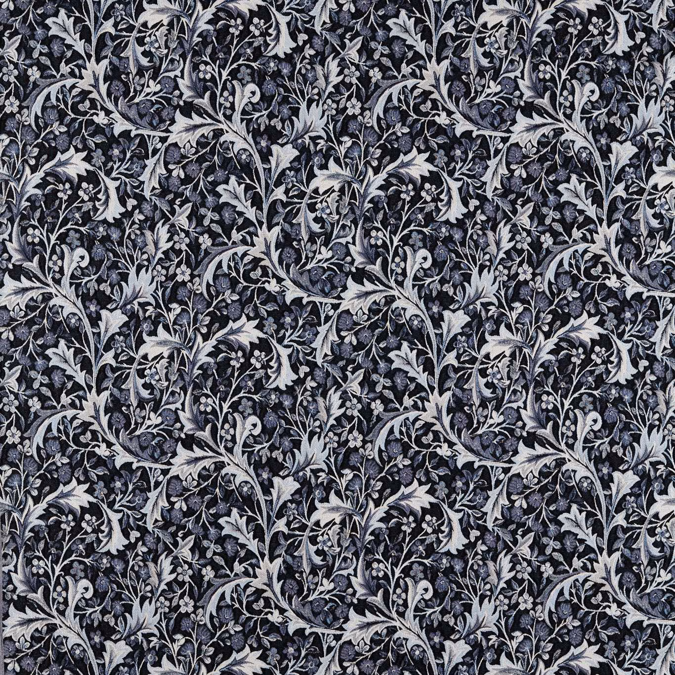 Dense indigo woven fabric with pale grey botanical vines, leaves and curling flowers