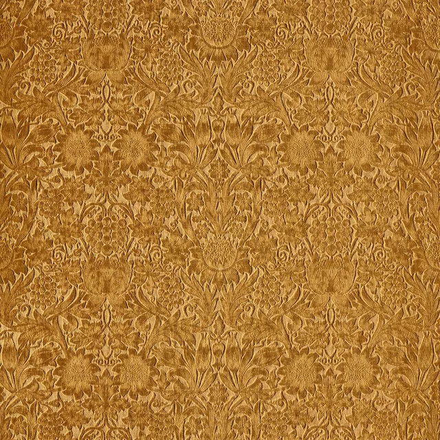 Warm ochre-gold velvet with an ornate symmetrical floral damask and softly shaded pile