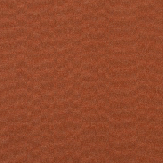 Close-up of warm burnt amber wool with a fine, even woven texture.