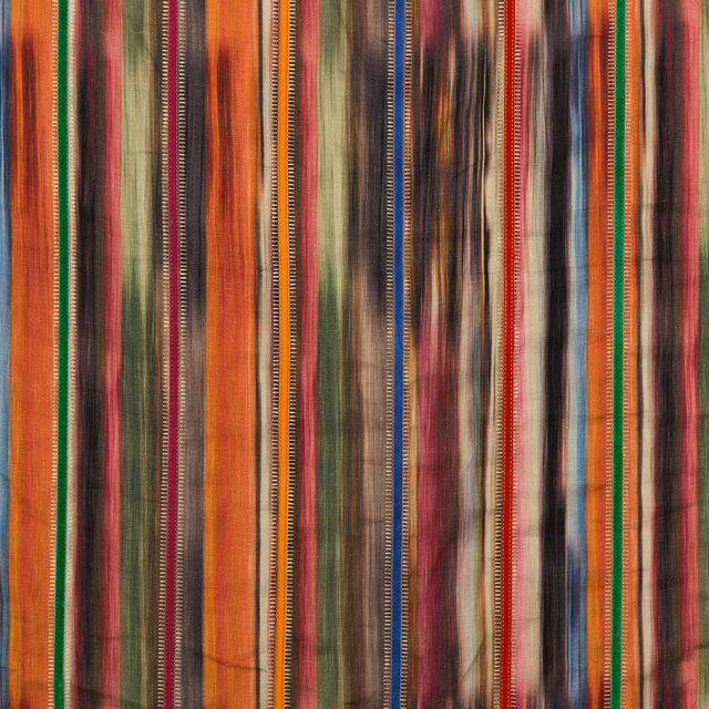 Close view of warm multicoloured linen with irregular vertical stripes and textured bands