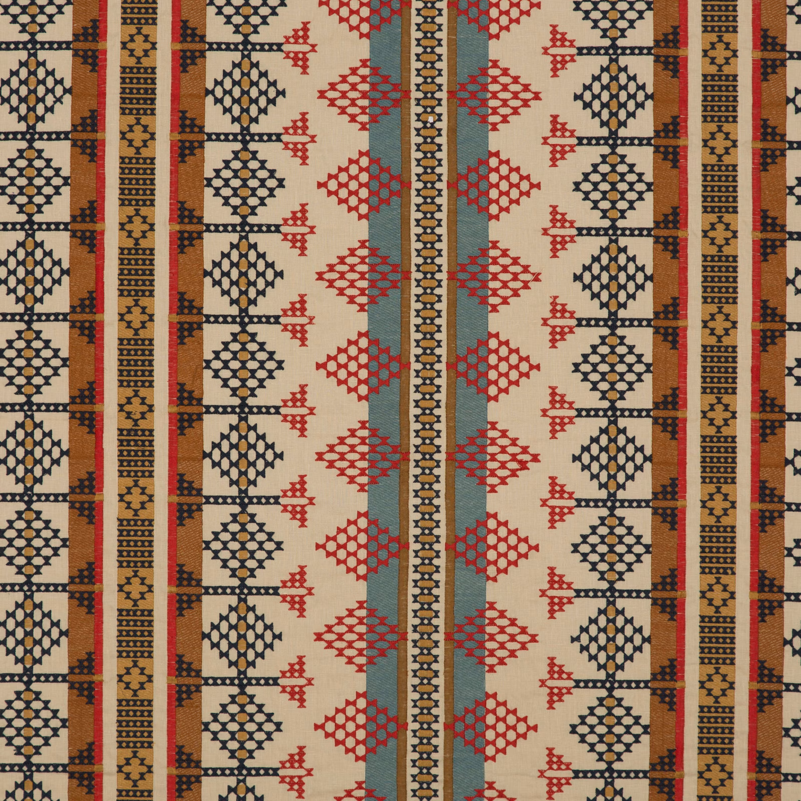Indigo, red and sand woven fabric with repeating diamond and stripe motifs
