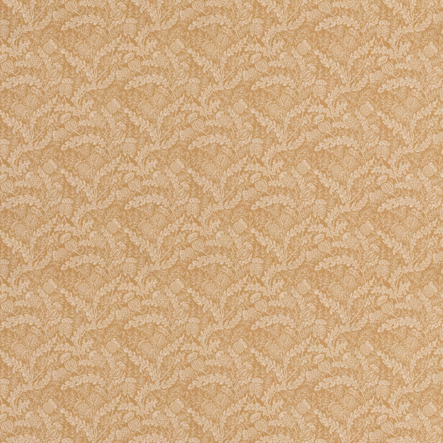 Warm ochre cotton with pale scrolling leaf tracery and a softly textured weave