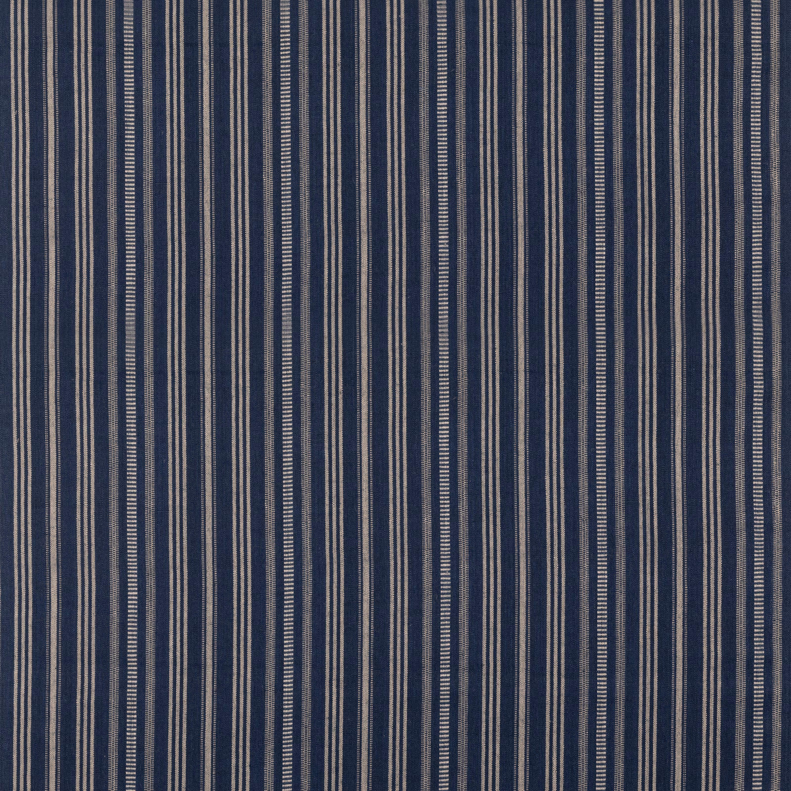 Deep indigo woven fabric with varied narrow cream vertical stripes and tactile texture