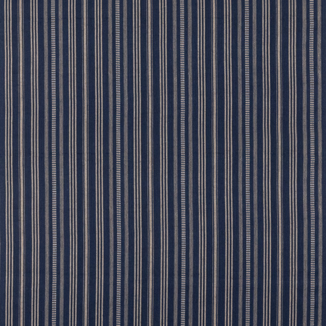 Deep indigo woven fabric with varied narrow cream vertical stripes and tactile texture