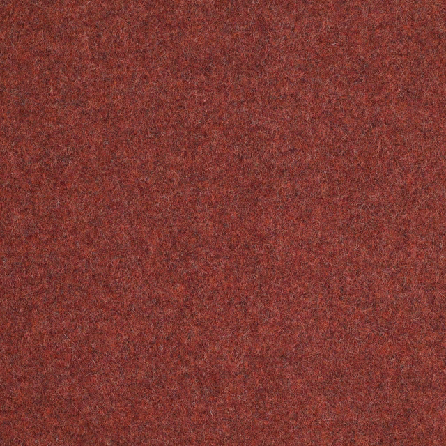 Close-up of mottled rust-red textile with a softly napped, flecked surface