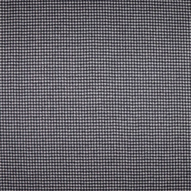 Close view of charcoal-grey micro houndstooth with a dense black and pale grey weave