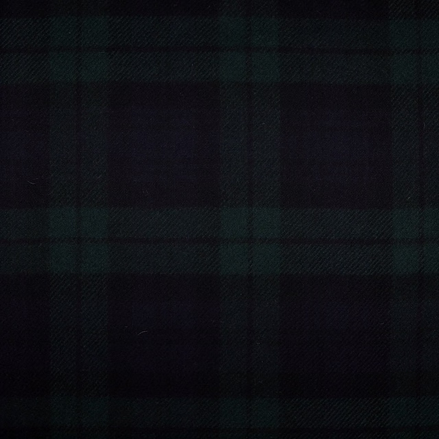 Near-black woven plaid with subdued forest-green checks and a softly textured surface