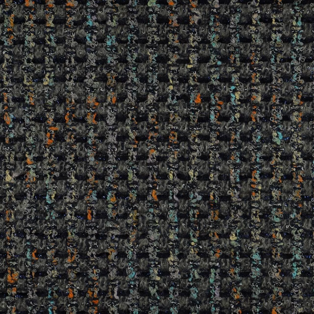Charcoal woven upholstery with tiny looping marks and muted teal and rust flecks