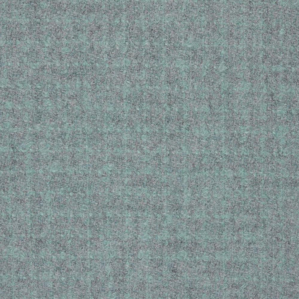 Close-up of muted aqua-teal textile with fine blue-grey mottling and soft surface texture