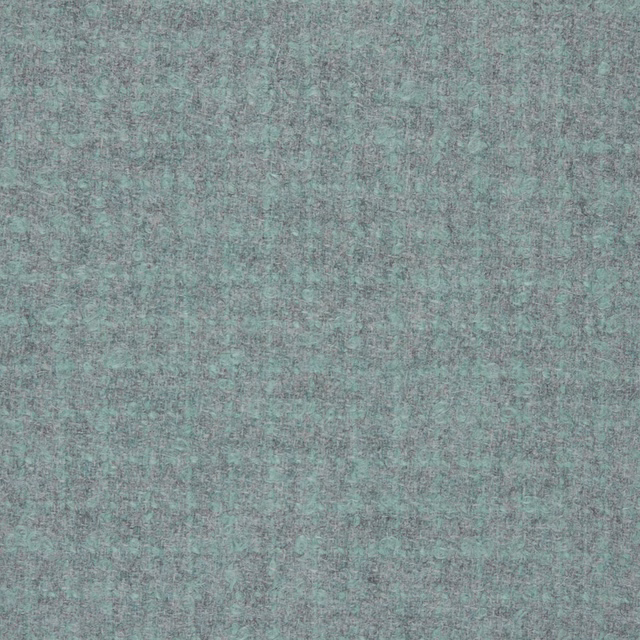 Close-up of muted aqua-teal textile with fine blue-grey mottling and soft surface texture
