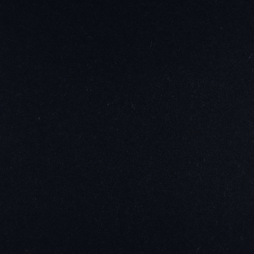 Near-black, subtly mottled textile surface with a cool ink-blue cast