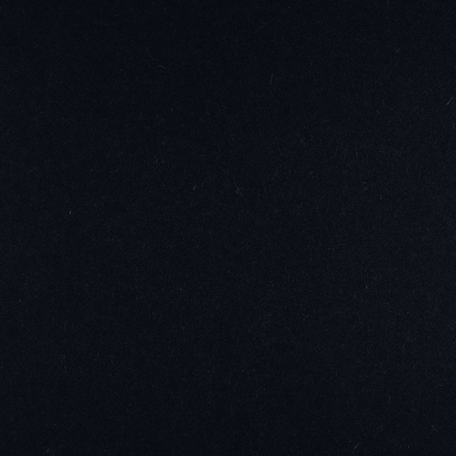 Near-black, subtly mottled textile surface with a cool ink-blue cast