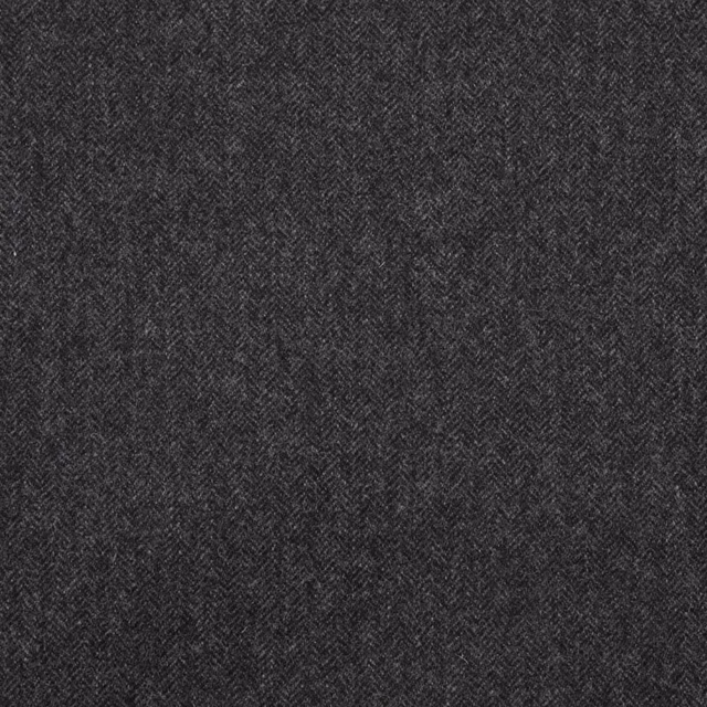 Close-up of deep charcoal fabric with a fine tonal herringbone weave