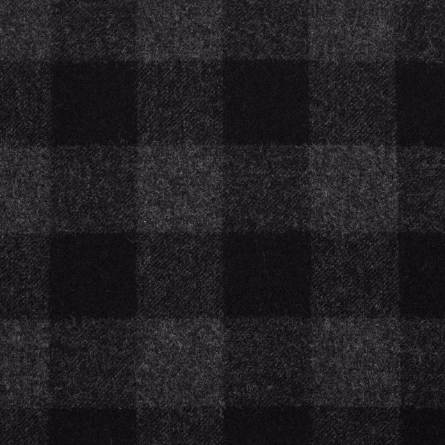 Black and charcoal checked textile with a softly brushed, flecked weave