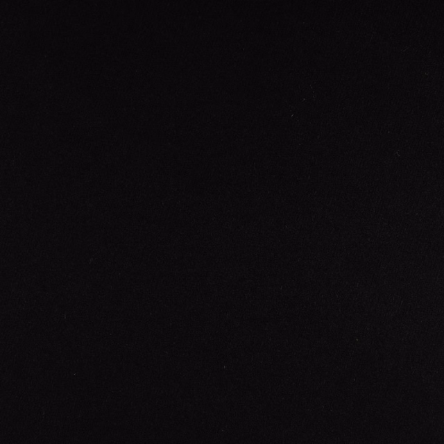 Near-black fabric swatch showing fine low-sheen texture with subtle tonal grain