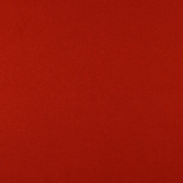Close-up of deep crimson red fabric with a fine, even woven texture