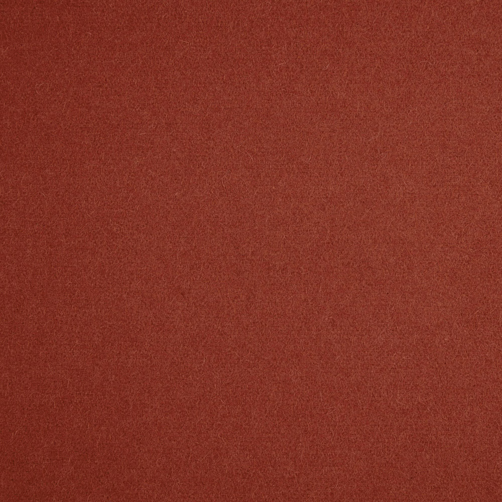 Close-up of deep russet terracotta fabric with a fine, softly textured plain surface