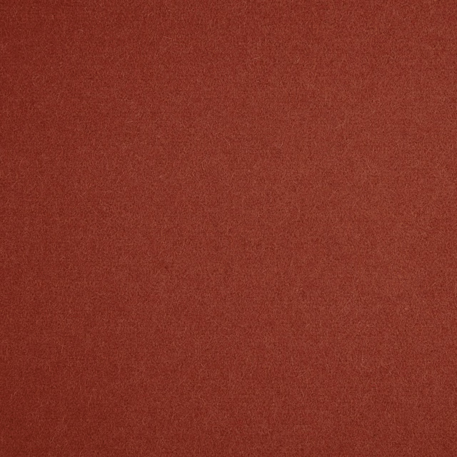 Close-up of deep russet terracotta fabric with a fine, softly textured plain surface