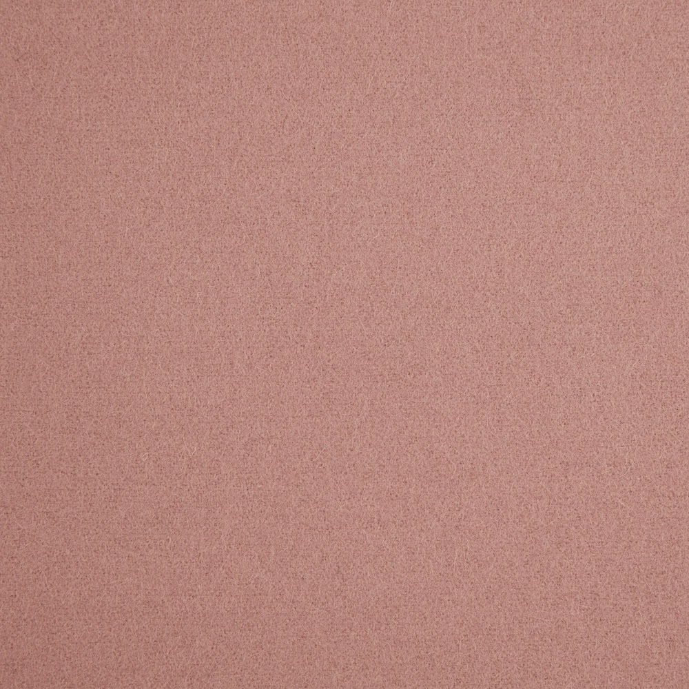 Close-up of muted dusty rose fabric with a fine softly mottled texture