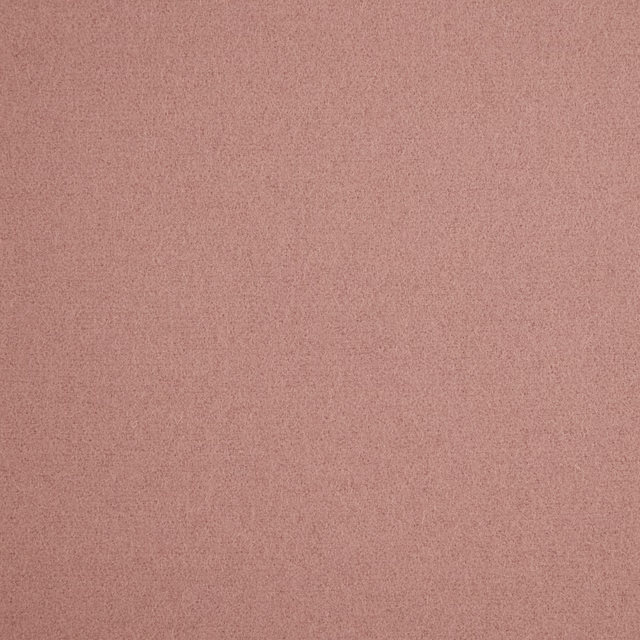 Close-up of muted dusty rose fabric with a fine softly mottled texture