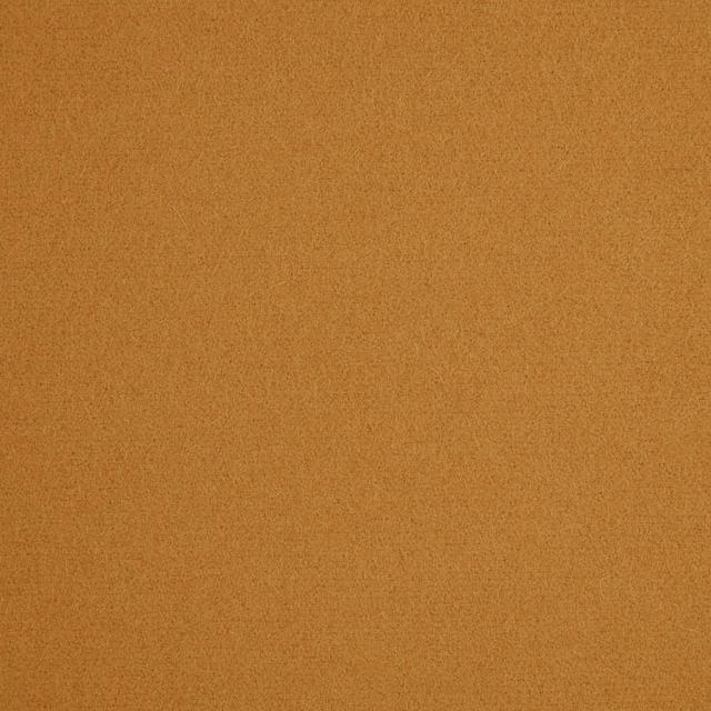 Warm ochre-brown plain fabric with a fine, softly mottled texture